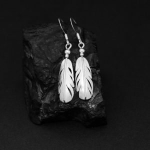 Feather earrings by Harvey Chavez