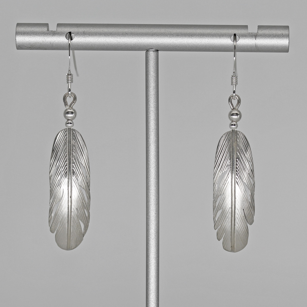 silver feather earrings by Harvey Chavez