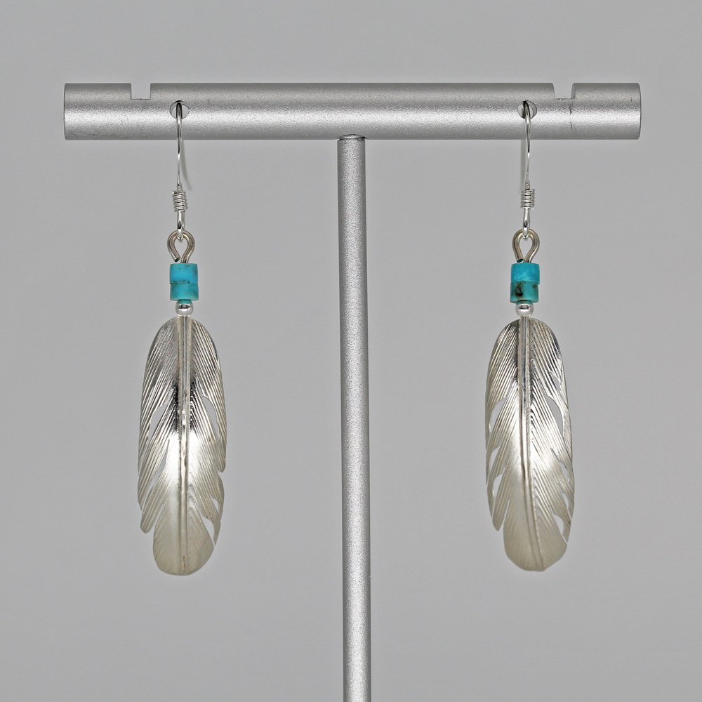 Feather earrings by Harvey Chavez