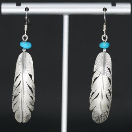 Feather earrings by Harvey Chavez