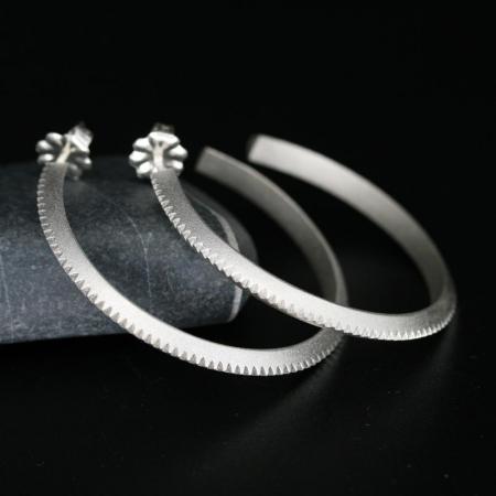 Silver hoop earrings by Chris Pruitt